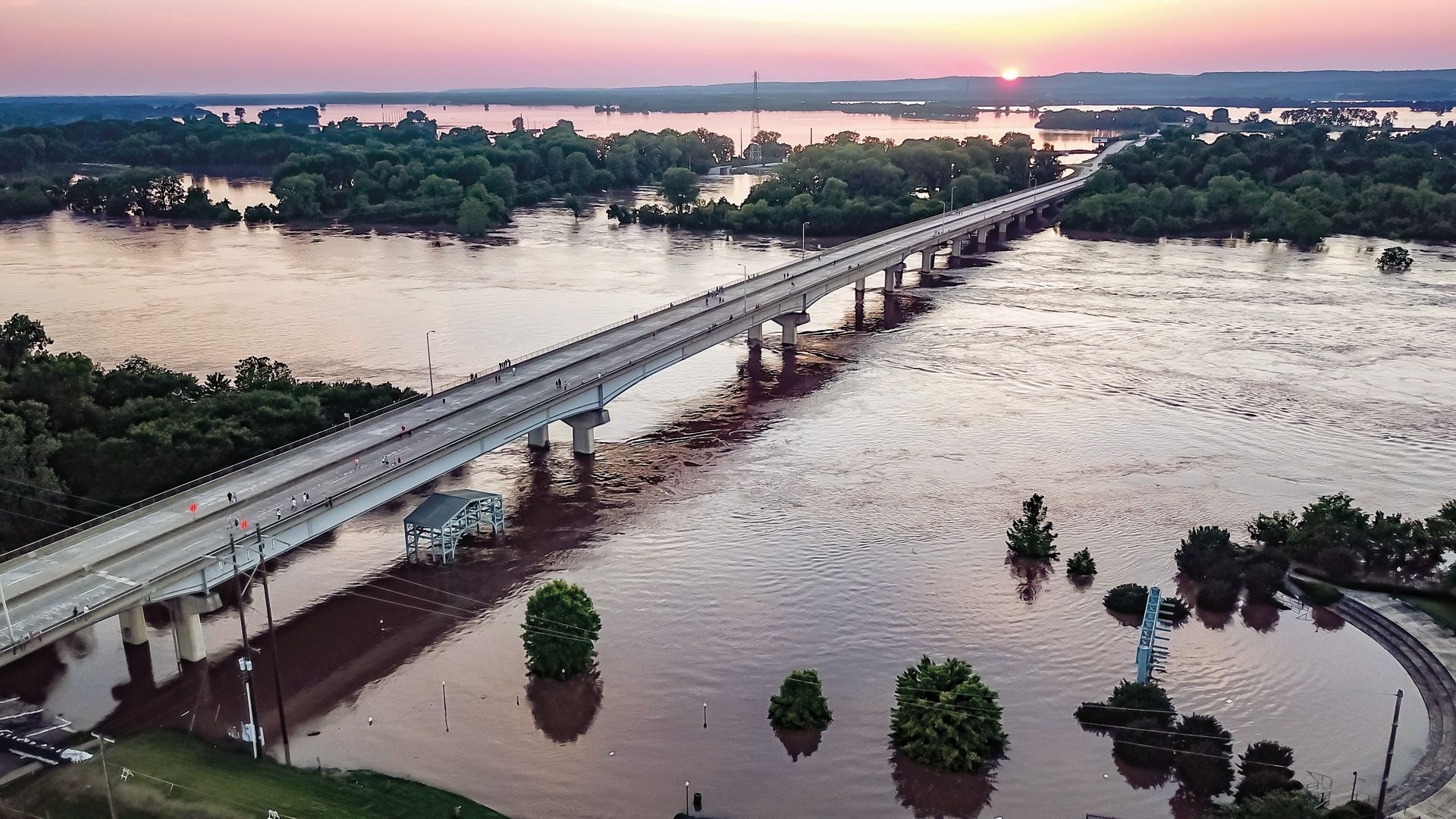 Photo by Austin Collins. May 31, sunset over the flooded Arkansas River spilling into Oklahoma.